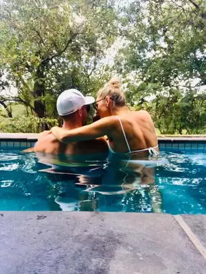 a man and a woman in a swimming pool at Kruger Willows in Marloth Park