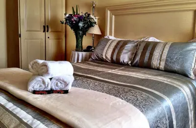 a bedroom with a bed with a stuffed animal on it at Pilgrims Delight Guest House in Centurion