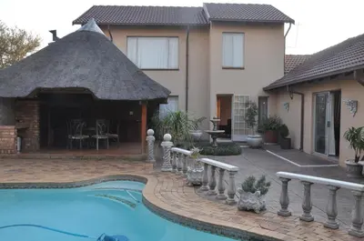a house with a swimming pool and a gazebo at Pilgrims Delight Guest House in Centurion