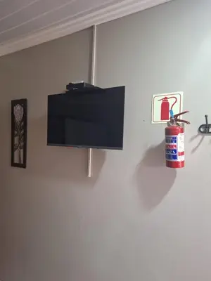 a flat screen tv hanging on a wall at 9 Levubu Cottages in Polokwane
