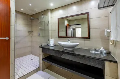 a bathroom with a sink and a mirror at African Sky Ermelo Inn in Ermelo