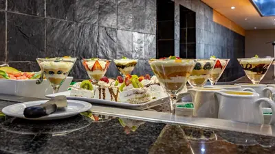 a buffet of desserts and drinks on a table at African Sky Ermelo Inn in Ermelo