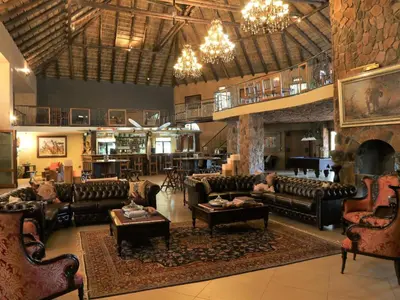 a large living room with couches and a fireplace at Shelanti Game Reserve in Marken
