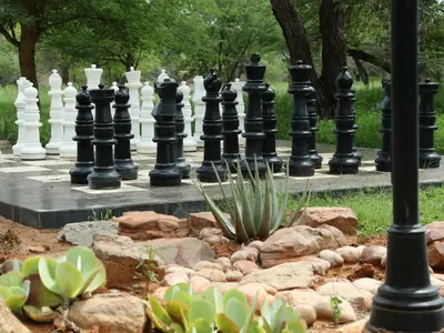 a large chess board in a garden with rocks at Shelanti Game Reserve in Marken