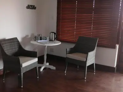 two chairs and a table in a room with a table at Shelanti Game Reserve in Marken