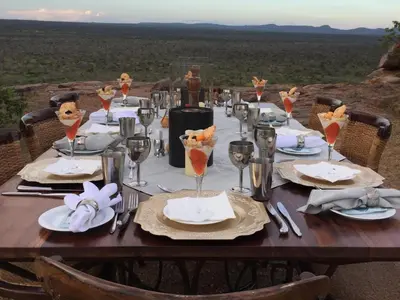 a table set for a meal with a view of the desert at Shelanti Game Reserve in Marken