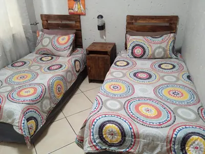 two beds sitting next to each other in a room at Bellamia in Marloth Park