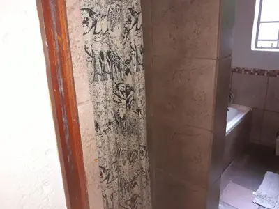 a shower in a bathroom with a shower curtain at Bellamia in Marloth Park