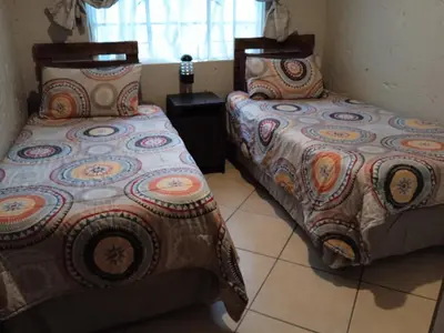 two beds sitting next to each other in a room at Bellamia in Marloth Park