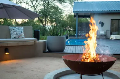 a fire pit in the middle of a patio at Rafiki Bush Lodge in Hoedspruit