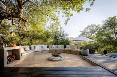an outdoor patio with couches and a table at Rafiki Bush Lodge in Hoedspruit
