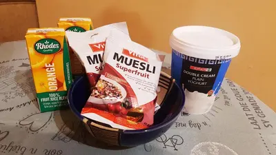 a basket with some food and a cup of coffee at Raka Cottage in Nelspruit