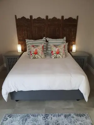 a large white bed with pillows on top of it at NOOii - Flatlet in Pretoria