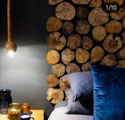 a bedroom with a wall made out of logs at Treur River Lodge in Moremela