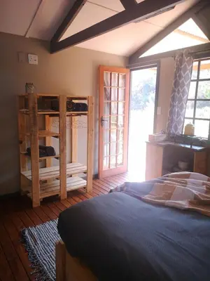 a bedroom with a large bed and a window at Treur River Lodge in Moremela