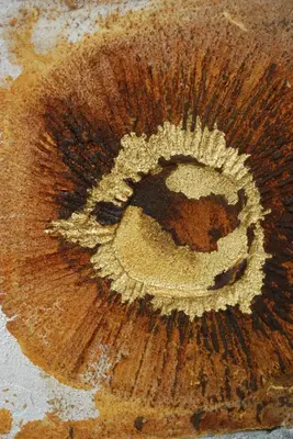 a close up of a wooden table with a painting on it at The Lofts in Polokwane