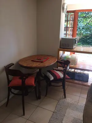 a table and chairs in a kitchen with a window at Air on Edward in Pretoria