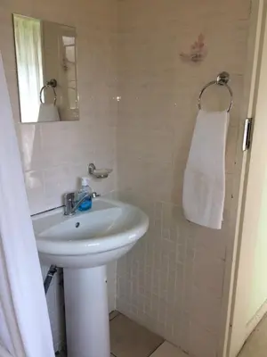 a bathroom with a sink and a mirror at Air on Edward in Pretoria