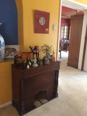 a room with a fireplace with a clock on the wall at Air on Edward in Pretoria