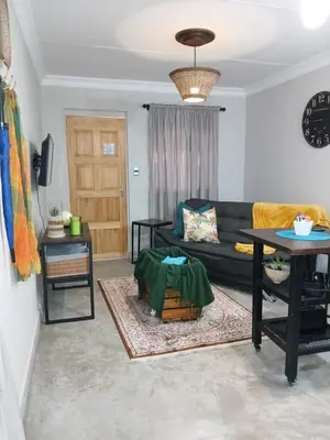 a living room with a couch and a table at LISANÉ ACCOMMODATION in Middelburg