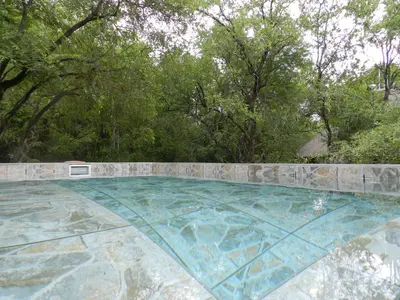 a swimming pool in the middle of a yard at BUFFALO in Marloth Park