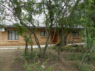 a brick house with trees in front of it at BUFFALO in Marloth Park