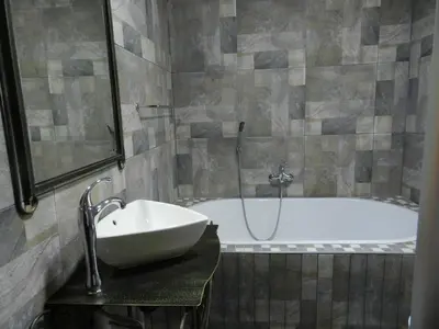 a bathroom with a sink and a bath tub at BUFFALO in Marloth Park