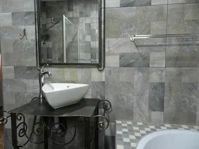 a bathroom with a sink and a tub and a mirror at BUFFALO in Marloth Park