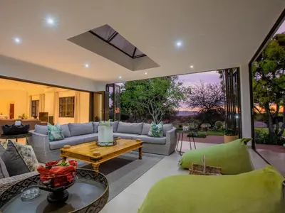 a living room with a couch and a table at Naledi@53 Private Game Farm in Brits