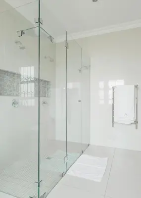 a glass shower stall in a white bathroom at Naledi@53 Private Game Farm in Brits