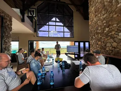 a group of people sitting around a table in a restaurant at Itaga View, Mabalingwe in Mabula