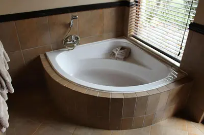 a bath tub in a bathroom with a window at Itaga View, Mabalingwe in Mabula