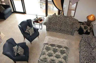a living room with couches and a table with chairs at Itaga View, Mabalingwe in Mabula