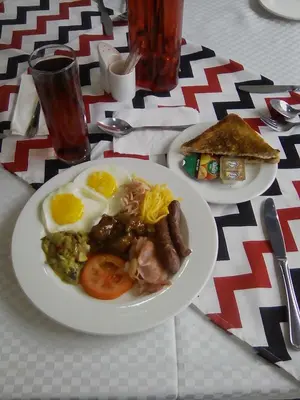 a table with two plates of food with eggs and toast at Big Ben Lodge in Polokwane