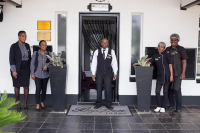 a group of people standing in front of a door at Big Ben Lodge in Polokwane