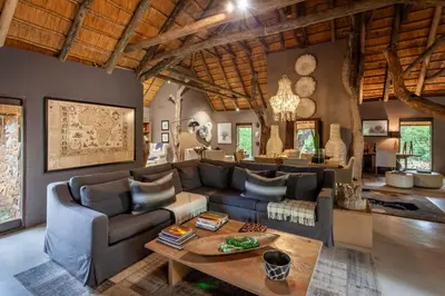a living room with a couch and a table at Leopard Hills Private Game Reserve in Sabi Sand Game Reserve