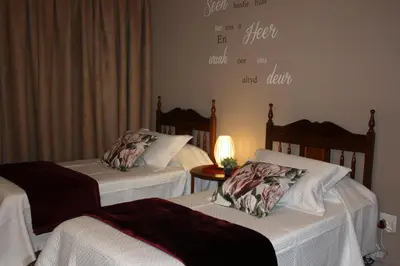 a room with two beds and a sign on the wall at Little Umhlanga in Pretoria
