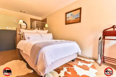 a bedroom with a large bed in a room at Cinzaco Dullstroom in Dullstroom