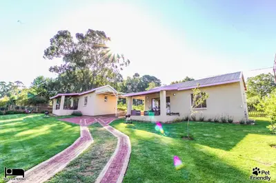 a house with a green lawn in front of it at Cinzaco Dullstroom in Dullstroom
