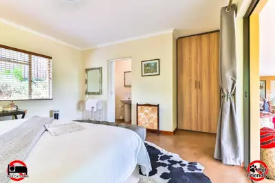 a bedroom with a bed and a fireplace at Cinzaco Dullstroom in Dullstroom