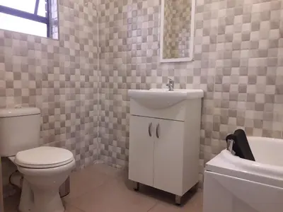 a bathroom with a toilet and a sink and a tub at Vakhusi Guesthouse in Malamulele