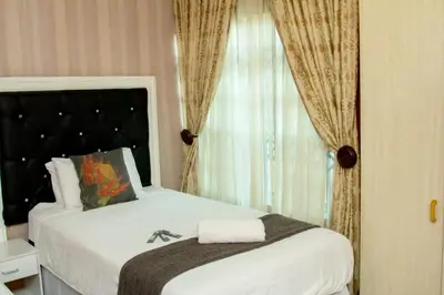 a bedroom with a large bed with a window at Vakhusi Guesthouse in Malamulele