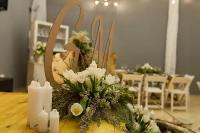 a table with white flowers and candles on it at Loskop Valley Lodge in Groblersdal
