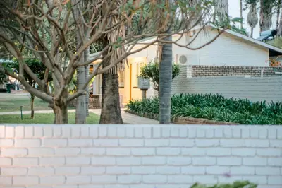a brick wall in front of a house at Loskop Valley Lodge in Groblersdal