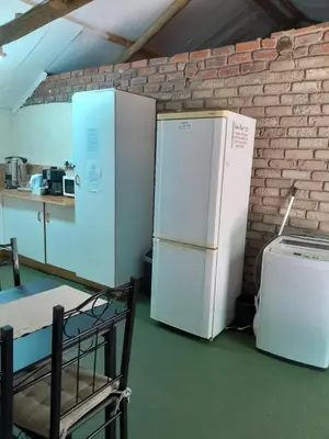two refrigerators are sitting next to a brick wall at Shala Mushe Tented Camp & Camp in Bela-Bela