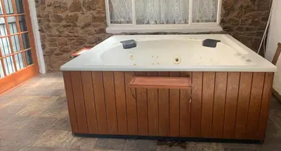 a jacuzzi tub in a room with a window at Shala Mushe Tented Camp & Camp in Bela-Bela