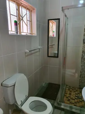 a bathroom with a toilet and a shower at RS GARDEN GUESTHOUSE in Thohoyandou