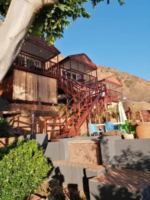 a large building with a deck with chairs on it at Letamong in Hartbeespoort