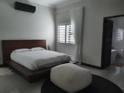 a bedroom with a large bed and a large window at Best of Both in Pecanwood Estate in Hartbeespoort