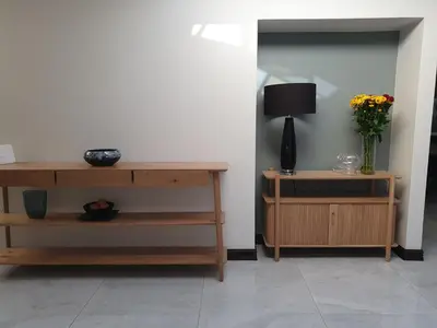 a living room with a table and a vase of flowers at Best of Both in Pecanwood Estate in Hartbeespoort
